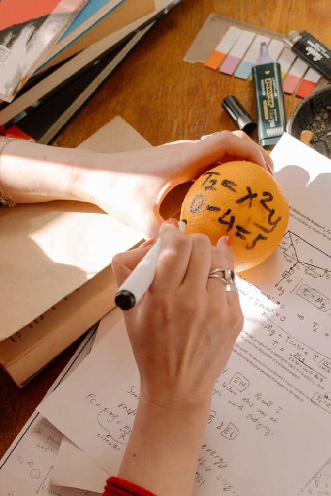 person holding orange and white round ornament